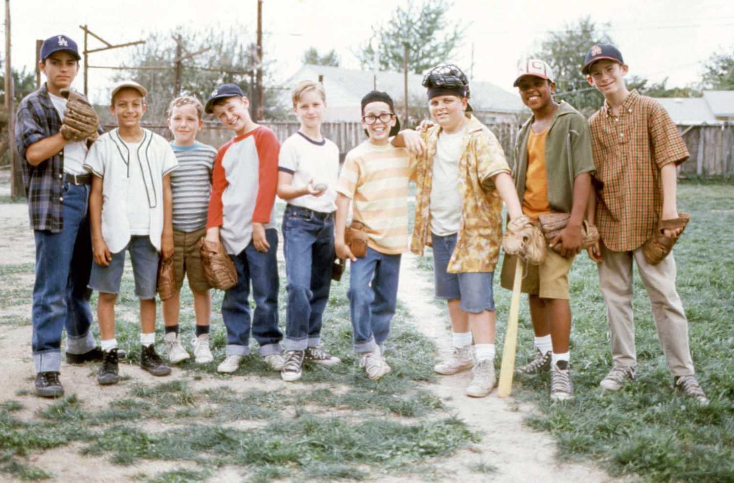 Sandlot League players gathered on a dirt diamond, gloves in hand, late summer afternoon